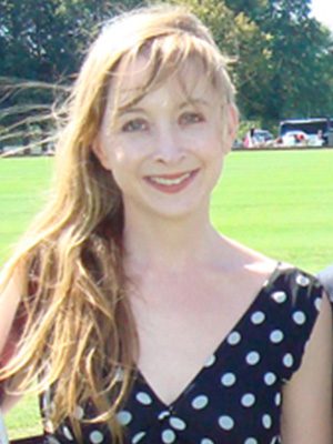 A woman with long hair and a polka dot dress.