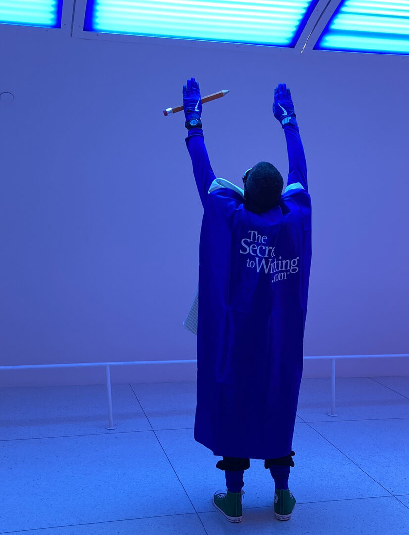 A person in blue cape holding a sword.