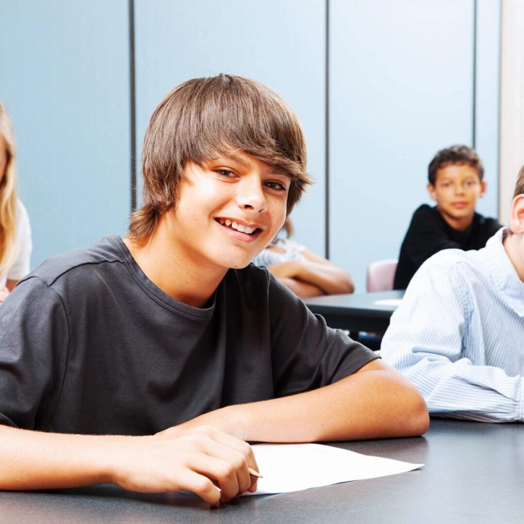 A group of young people sitting at a table.